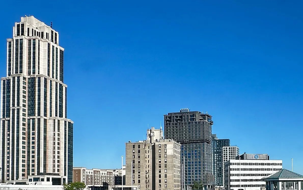 High-rise buildings of downtown New Rochelle against a clear blue sky